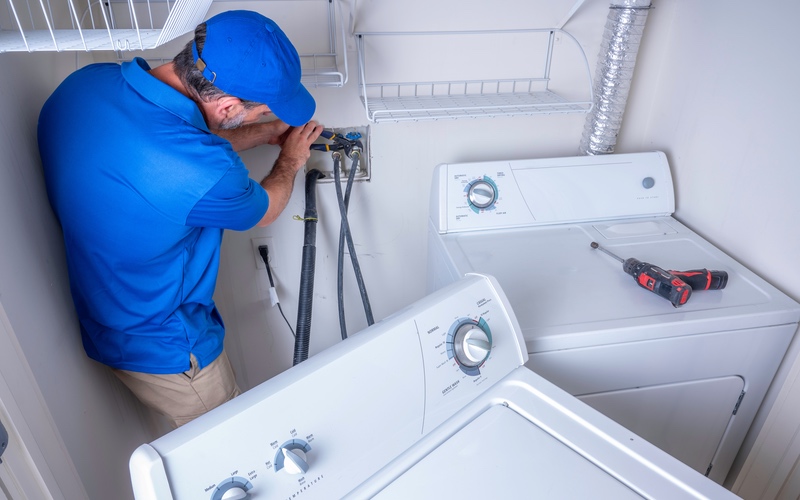 A service provider from WyattWorks providing washing machine drain plumbing in Cleveland, OH.